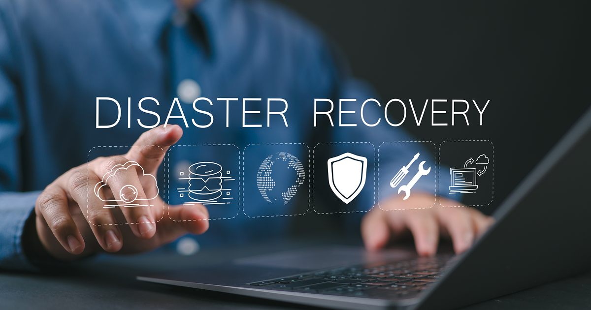 Disaster recovery concept, IT system protection. Man using laptop with disaster recovery icon on virtual screen. Restoring critical systems and data.